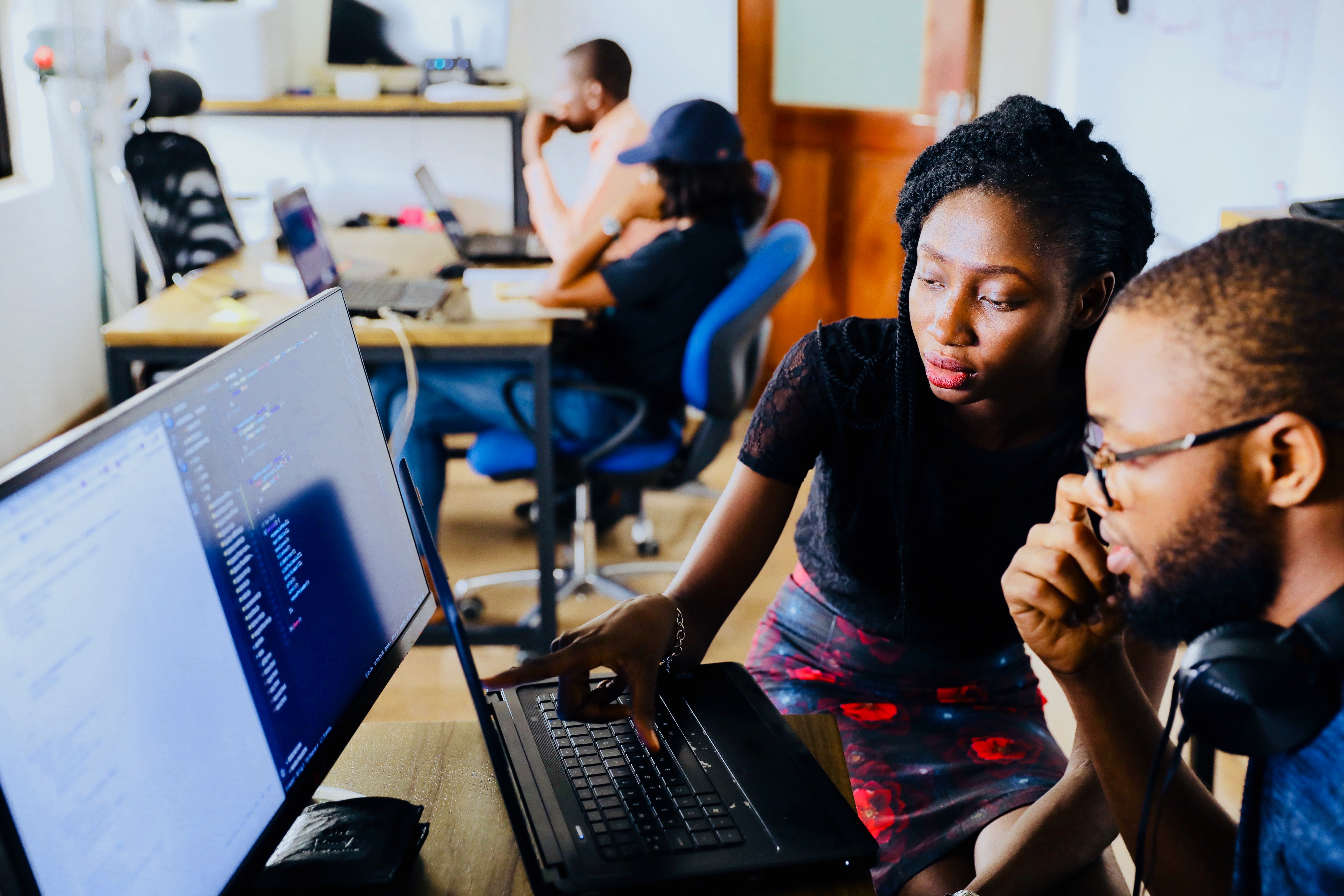 two people looking at computer code together