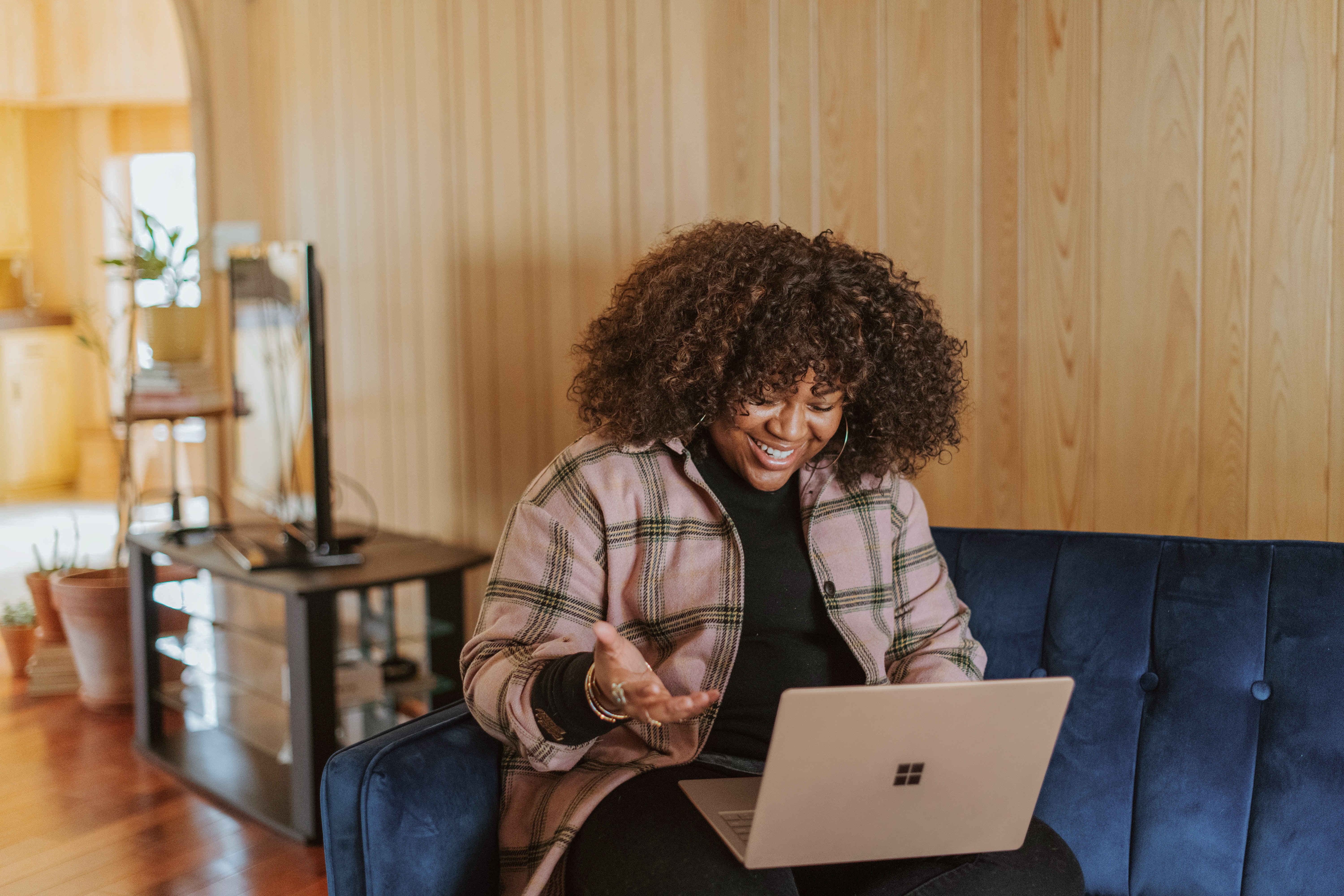 woman sitting smiling at her computer